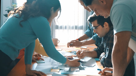Top view of skilled business team planning and looking blueprint. Group of smart business people working together discussing and talking about building construction while looking at tablet. Symposium.の写真素材