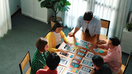 Creative team putting hand together while brainstorm about Ux Ui design mobile phone interface....