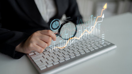 Modern business analysis scene featuring a keyboard and magnifying glass, showcasing graphs and...