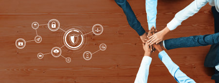 A group of diverse professionals join hands in a team collaboration effort, symbolizing unity and shared goals in developing cybersecurity solutions for digital protection.の写真素材