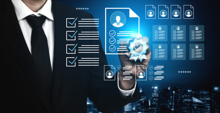 A business professional examines digital resumes using advanced technology in a modern urban office, showcasing the future of hiring and career management.の写真素材