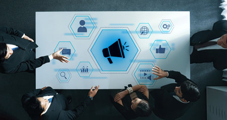Aerial view of a business meeting showcasing digital marketing concepts. Team members engage in...