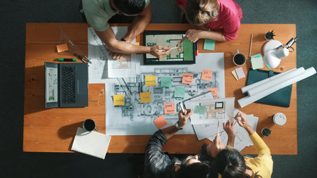 Top aerial view of interior designer planing building by using tablet at meeting. Group of architect engineer brainstorming idea and designing house structure while present idea to manager. Symposium.の写真素材