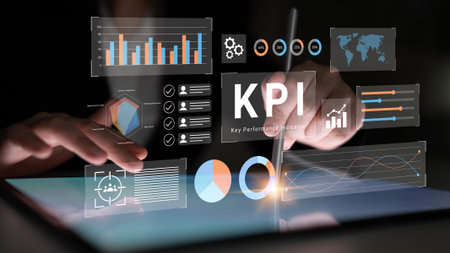 Close-up of hands using a digital tablet to explore key performance indicators with interactive graphs and charts for data-driven decision-making in business.の写真素材