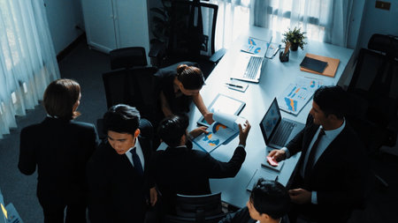 Top view of smart executive manager financial graph to diverse team while group of multicultural business people planning marketing strategy by using stock investment chart at meeting. Directorate.の写真素材