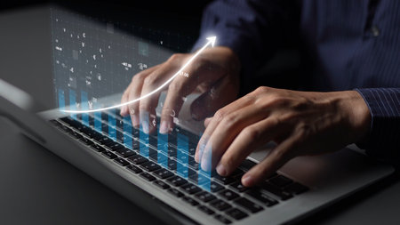 A focused business professional types on a laptop, with an overlay of graphs and data visualizations...