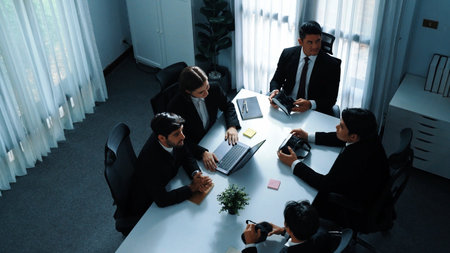 Top view of manager working on laptop and sending data analysis to business people by using VR glass headset while diverse team moving gesture while working together to planning idea. Directorate.の写真素材