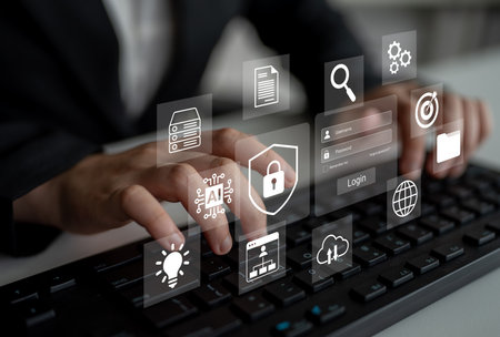 A professional user interacts with a digital interface displaying technology icons. This image represents modern computing, cybersecurity, and digital solutions for business.の写真素材