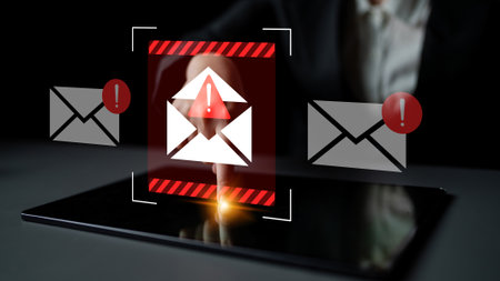 A conceptual image depicting a digital security alert with email notifications and warning symbols, illustrating the importance of cybersecurity and data protection.の写真素材