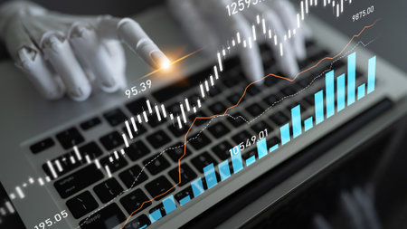 A close-up view of a robotic hand interacting with financial data on a laptop, showcasing modern technology in finance and investment strategy analysis for enhanced decision-making.の写真素材