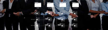 A diverse team of professionals collaborates in a modern office, strategically managing tasks and tracking progress using digital tools for maximum efficiency and productivity.の写真素材