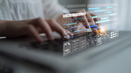 A modern office scene showcasing hands typing on a laptop, overlaid with digital task management and...