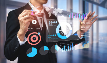 An engaged business professional interacts with a futuristic interface, analyzing digital graphs and metrics in a modern office, emphasizing data-driven decision making.の写真素材
