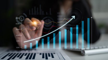 Business professional engaging with digital growth chart in a modern office, demonstrating data...