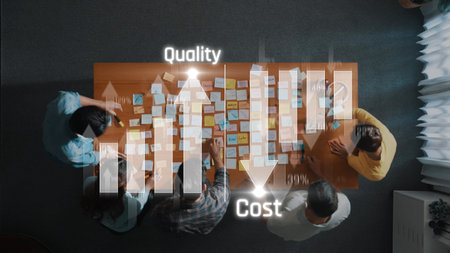A diverse team engages in a collaborative business analysis session, using sticky notes to visualize quality and cost metrics in a modern office setting. Rasterの写真素材