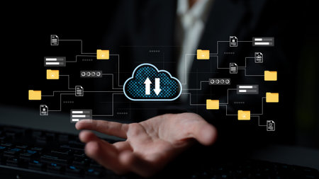 Hand reaching out to a cloud interface displaying upload and download icons, representing digital...