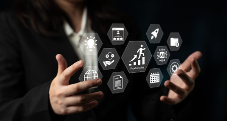 A business professional displays digital icons representing productivity and innovation. The visual...