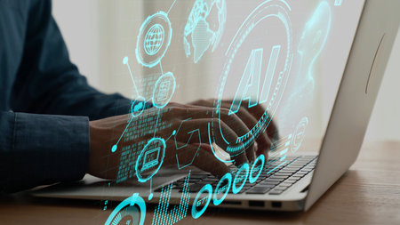A close-up view of hands typing on a laptop, surrounded by vibrant digital graphics representing...