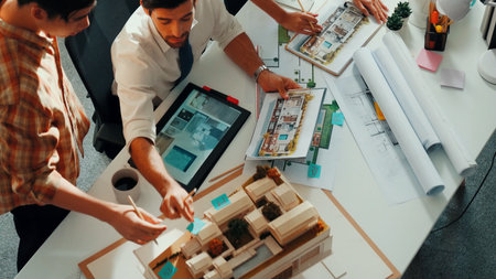 Top view of professional architect engineer team writing sticky notes and sticking note at meeting...