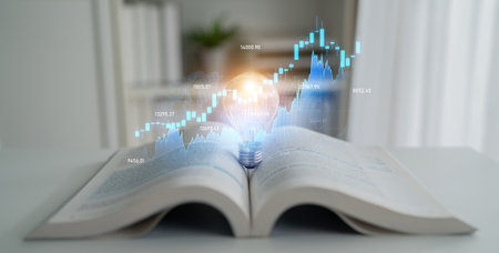 An open book with a glowing light bulb symbolizes knowledge infusion into financial growth. The chart visualizes market trends, showcasing investment opportunities and innovation.の写真素材