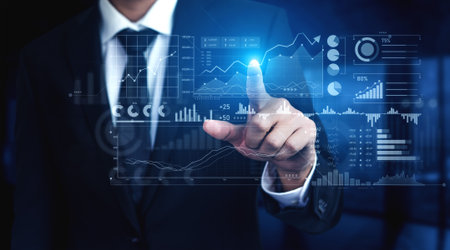 A businessman engages with a virtual data interface featuring financial graphs and analytics in a modern office, showcasing the blend of technology and business innovation.の写真素材