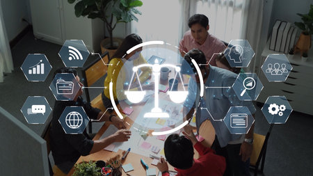 A diverse team engages in productive collaboration within a modern office, utilizing digital tools...