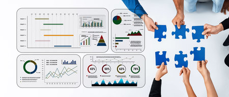 A team collaborates to complete a puzzle while analyzing data charts and graphs on a white table,...