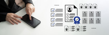 A business professional interacts with a smartphone while managing documents and verification processes, showcasing technology role in modern office efficiency.の写真素材