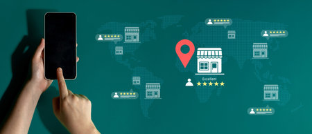 A hand holding a smartphone points to a location pin on a world map, illustrating the importance of...