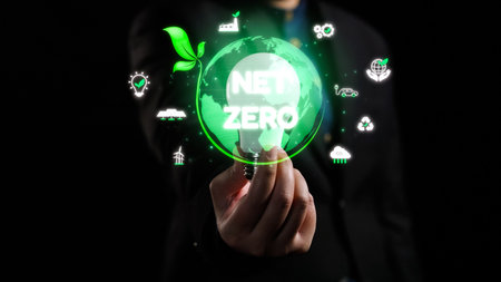 This image features a person holding a glowing green globe with the text Net Zero. It highlights...