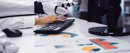 A robotic hand typing on a keyboard while surrounded by business reports and charts in a modern...