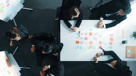 Top view of smart business group write marketing idea at whiteboard while present to executive manager. Investor clapping hands to celebrate successful project at table with sticky notes. Directorate.の写真素材