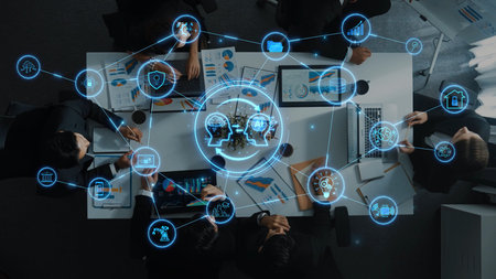 Aerial view of a collaborative meeting featuring various digital icons, emphasizing teamwork and...
