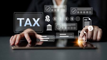 A person interacting with a tablet showcasing digital tax symbols emphasizes the importance of technology in modern financial management and tax preparation.の写真素材