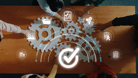 People collaborating in a work environment, using technology and gears to illustrate teamwork in...
