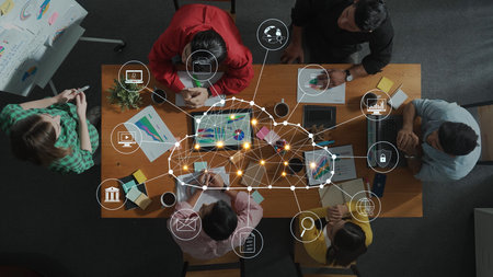 A diverse group of professionals collaborates on digital projects, sharing innovative ideas and utilizing technology in a modern office environment. Rasterの写真素材