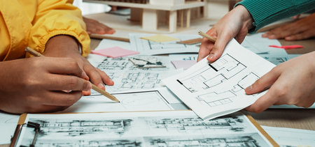 A dynamic collaborative session where architects and designers engage in sketching blueprints and...