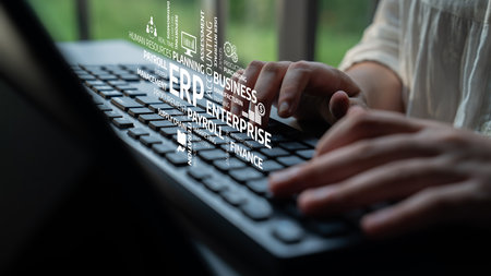 Hands typing on a keyboard in a modern office environment with business concepts visualized around, highlighting the importance of technology in enterprise solutions. Tesselの写真素材