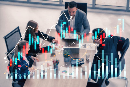Professional team discussing strategies while analyzing financial charts in a modern office. This image captures collaboration, data-driven decision-making, and business growth.の写真素材