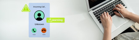 An individual receives an incoming call notification on a laptop, displaying an alert and warning icon, symbolizing the blend of communication and technology in daily life.の写真素材