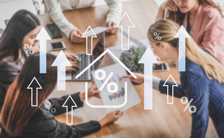 A group of professional women engage in a business meeting, analyzing financial growth trends with charts, laptops, and upward arrows symbolizing success and strategies.の写真素材