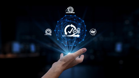 A hand reaches toward a glowing digital interface symbolizing data analysis, automation, and modern...