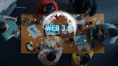 Aerial view of a diverse team collaborating on Web 3.0 strategies at a conference table with...