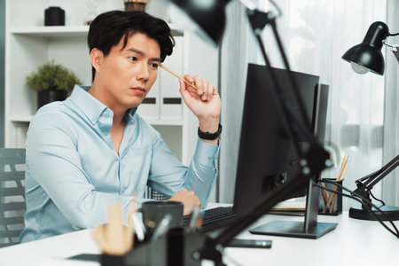 Serious smart businessman working on computer to check email with business project report, analyzing on market shares customer database in casual day at modern office in startup concept.の写真素材