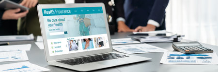 Panorama shot analyst team utilizing BI Fintech to analyze financial report with laptop. Businesspeople analyzing BI data dashboard displayed on laptop screen for business insight.の写真素材