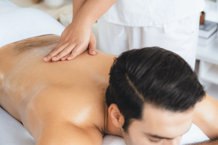 Caucasian man customer enjoying relaxing anti-stress spa massage and pampering with beauty skin...