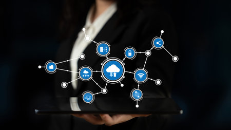Professional individual displaying a tablet with cloud technology and digital icons, symbolizing the...