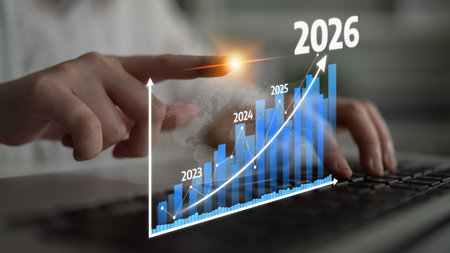 A close-up of a finger pointing at a growth projection chart on a laptop, highlighting financial...