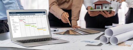 Group of interior architect designer discussing together on blueprint and laptop screen display architecture software for more precise designing layout. Modern home design and renovation. Insightの写真素材