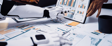 A futuristic robot arm showcases business charts while professionals engage in discussions. This...